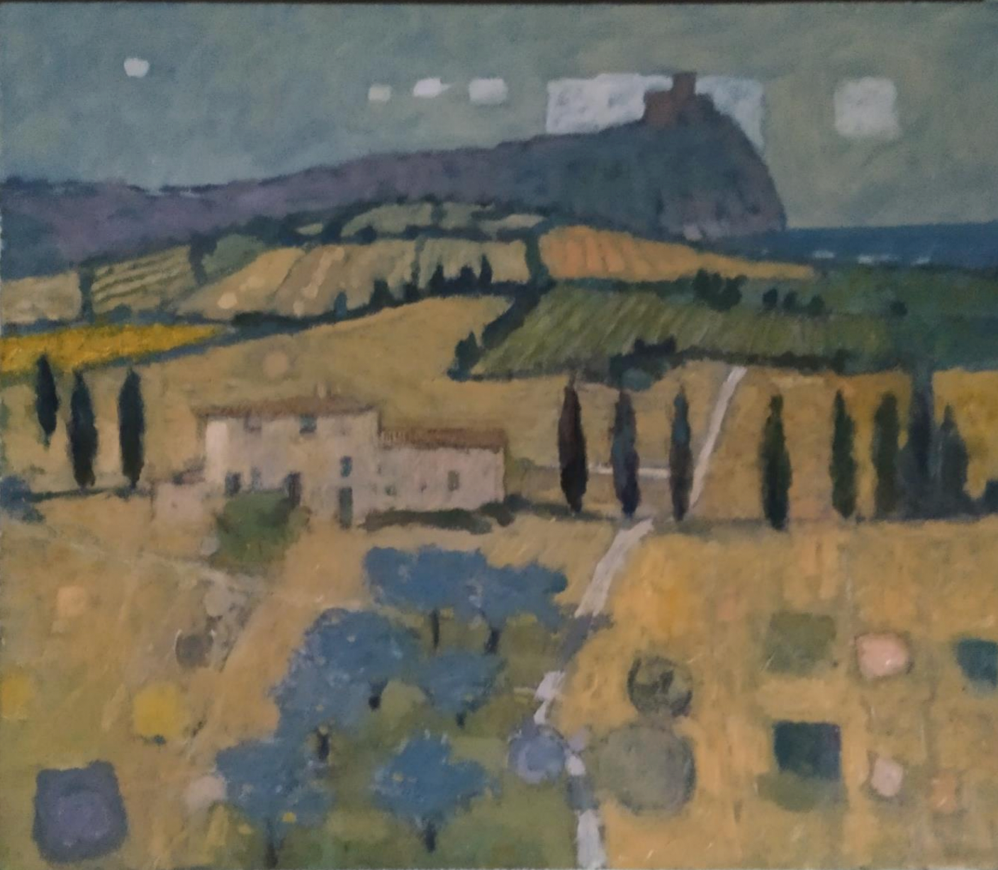 Rolling landscape with a farmhouse, tall trees, and a distant mountain under a cloudy sky.