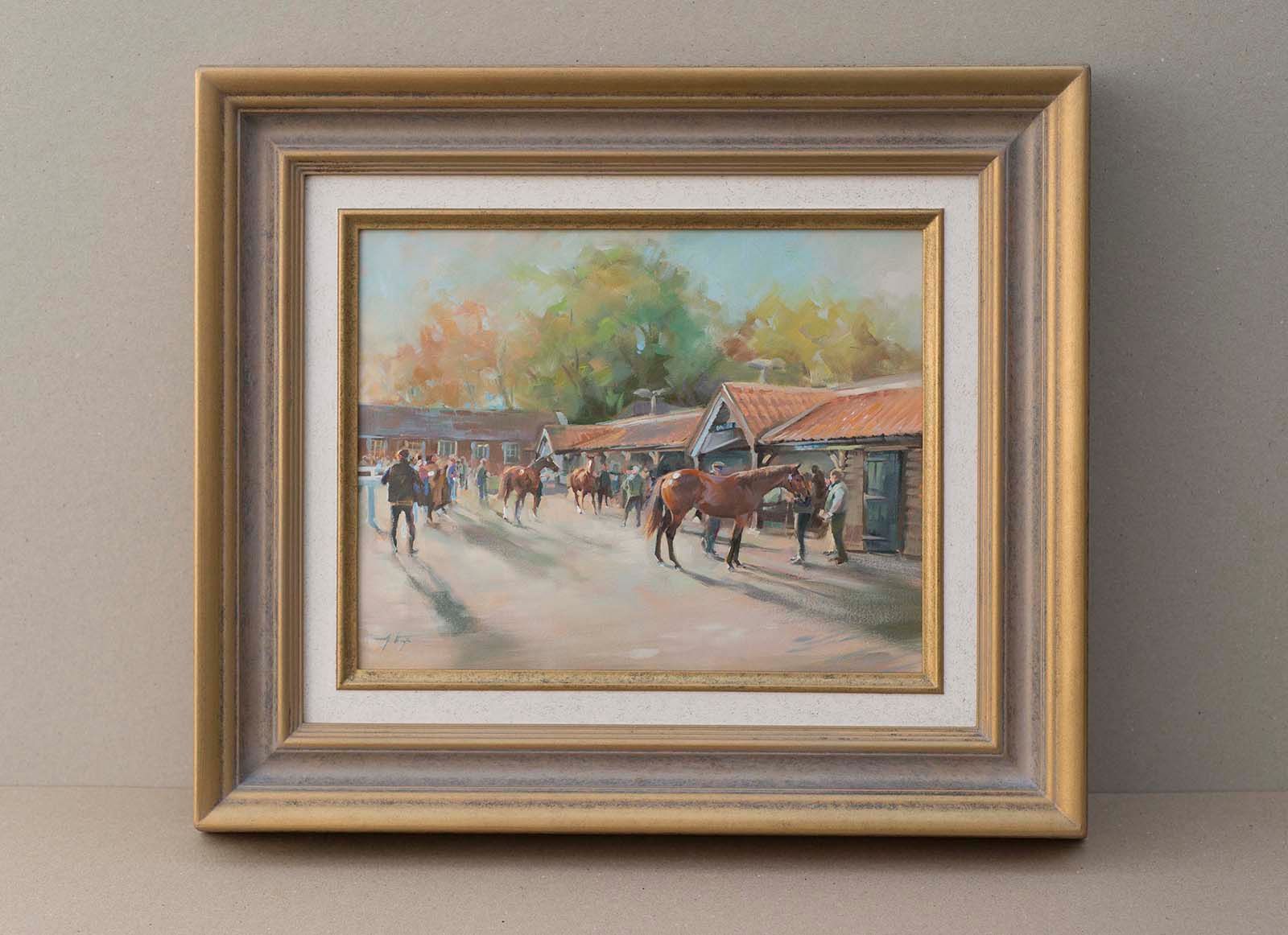 Framed painting of a street scene with people, horses, and red-roofed buildings