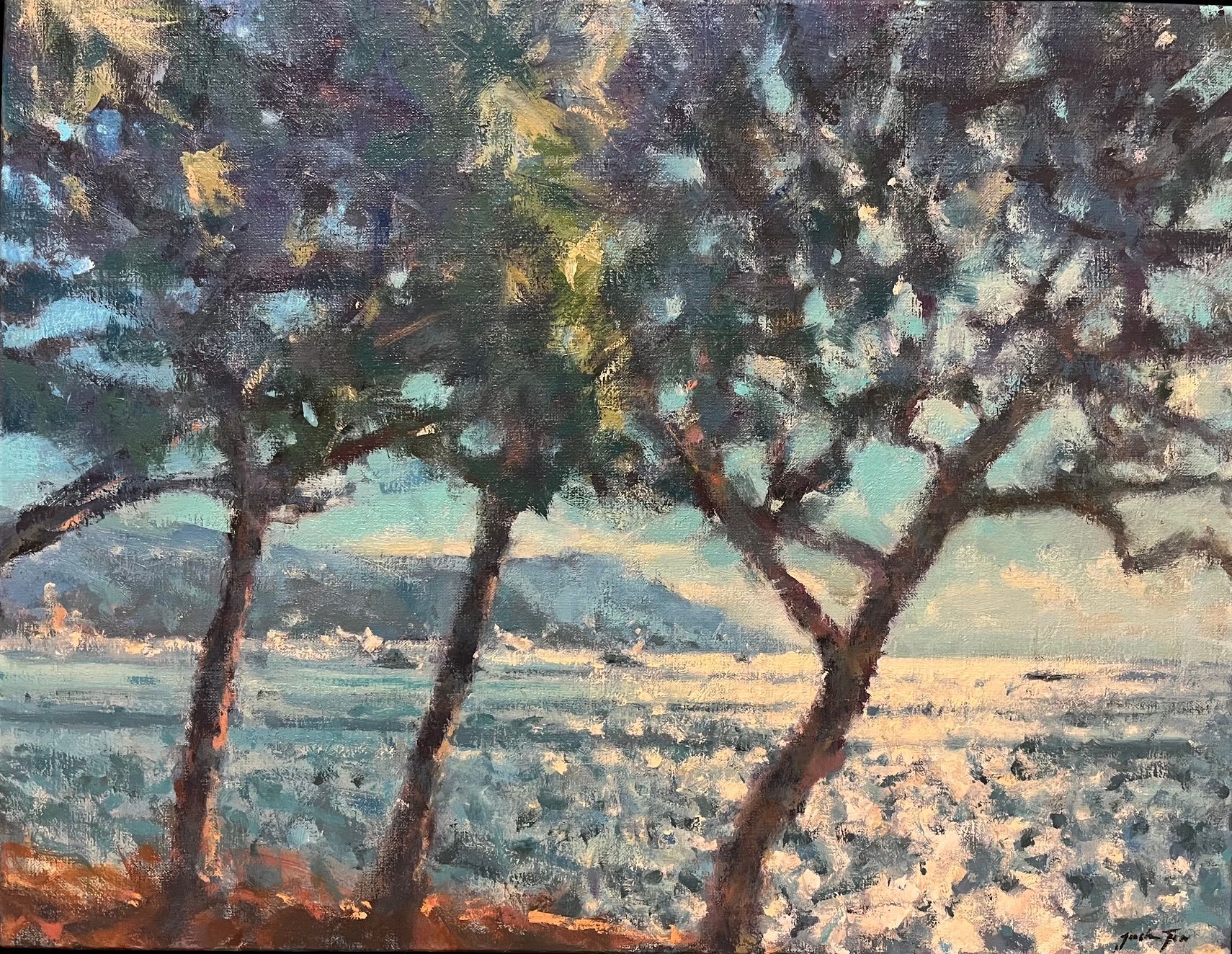 Trees silhouetted over a snowy field at sunrise, with pale blue and pink light in the sky