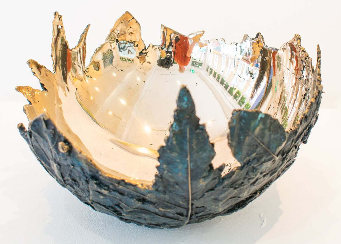 bronze bowl with jagged blue-gray and amber edges, shaped like a flower