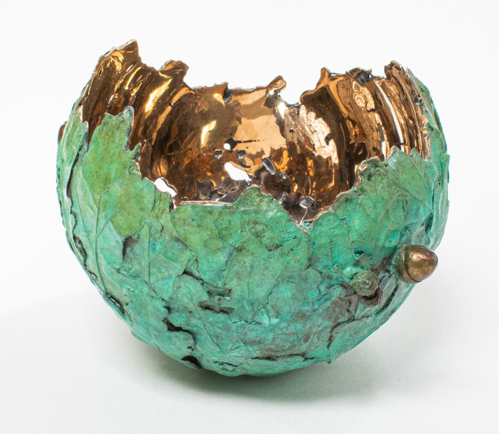 Green and bronze bowl, cracked open.