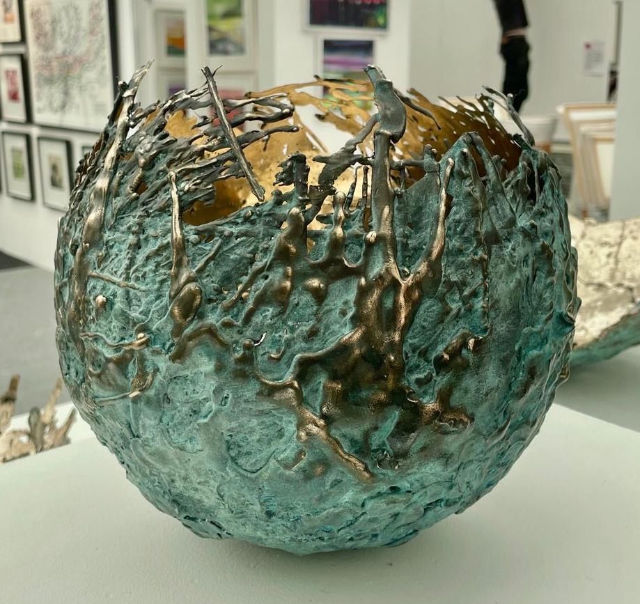 A blue and gold sculpture is sitting on a table.
