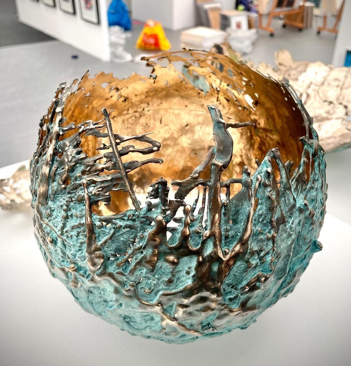 A blue and gold sculpture is sitting on a table.