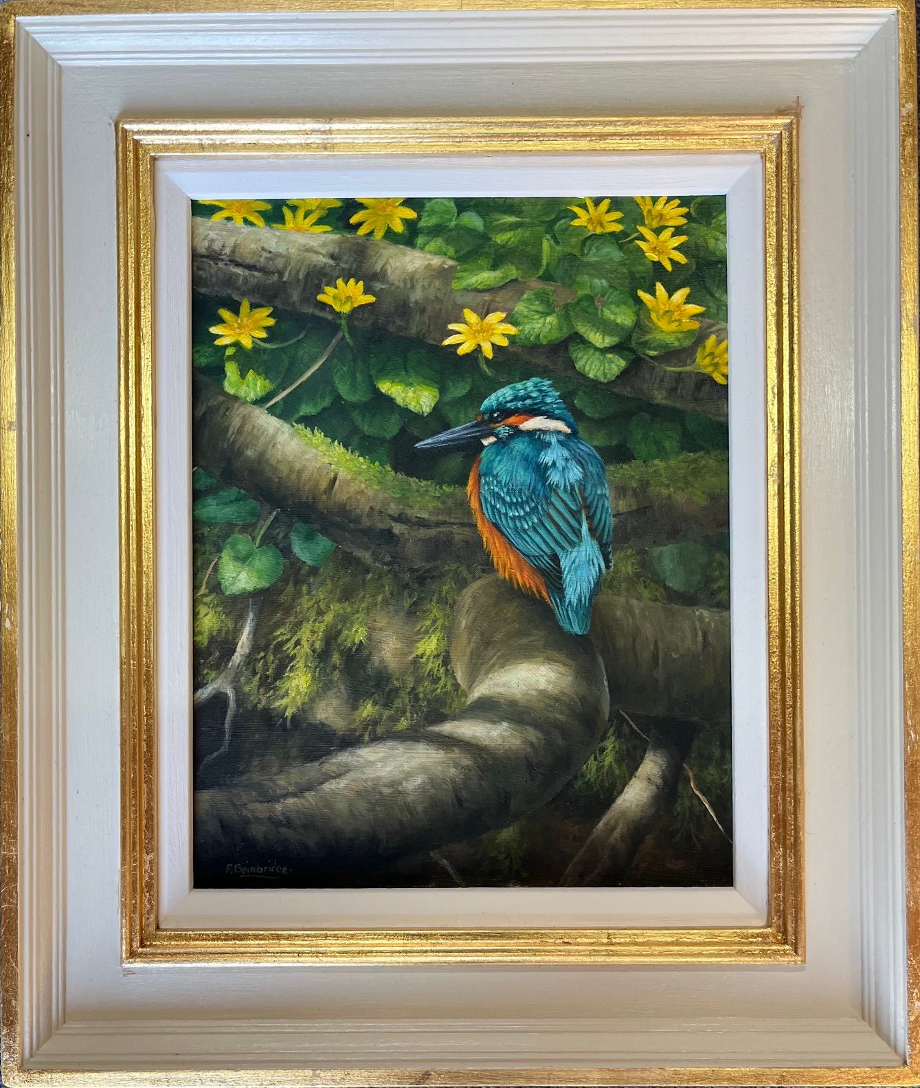 Blue-and-orange kingfisher perched on a branch amid yellow flowers and green foliage