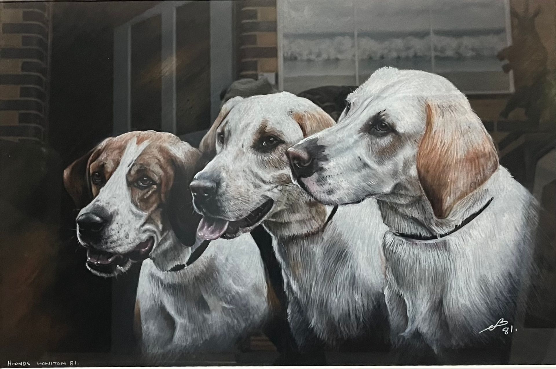 Three white and brown dogs with attentive expressions outside a building.