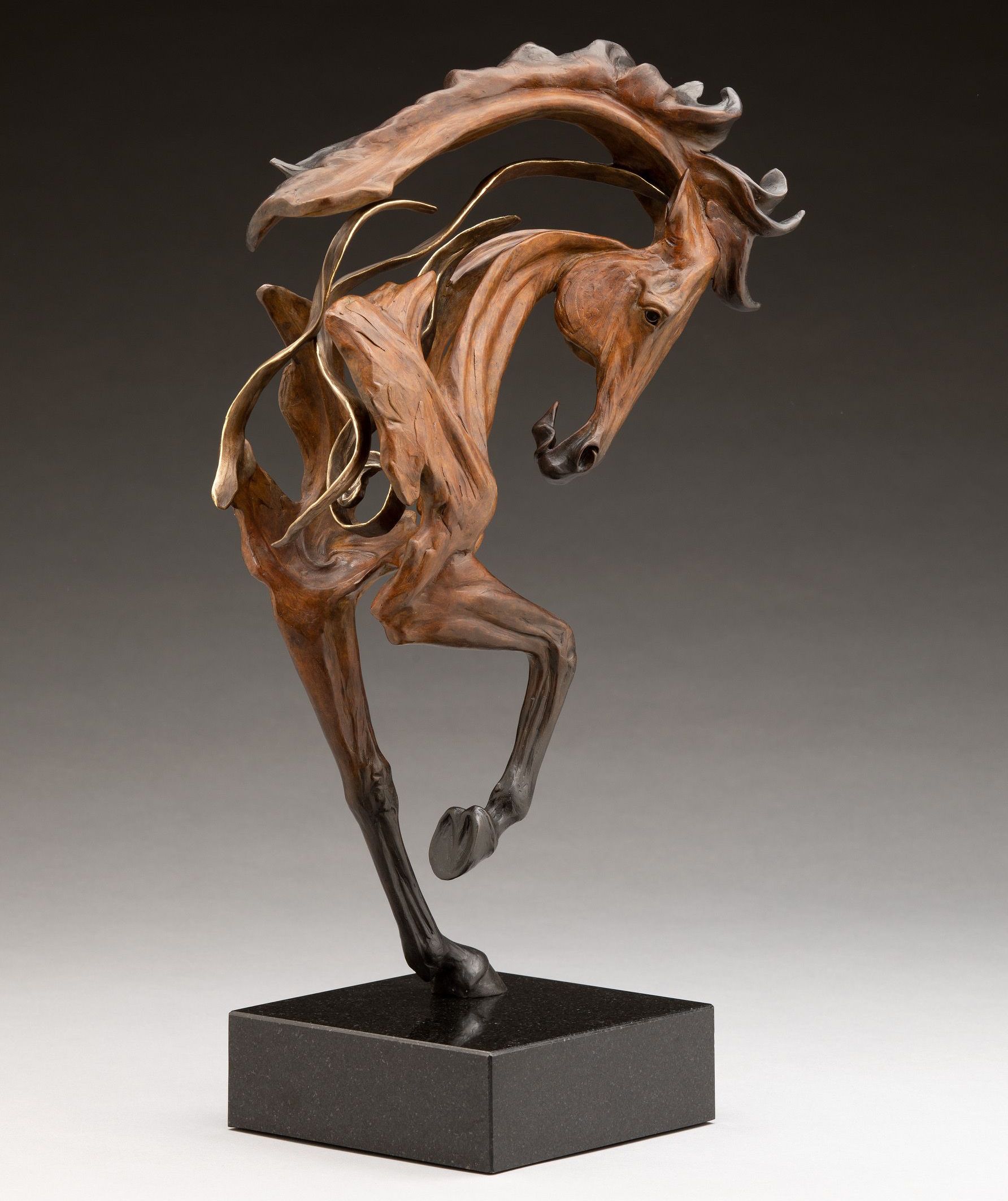 Bronze sculpture of a rearing horse, dynamic pose, brown with gold accents, mounted on a black square base.