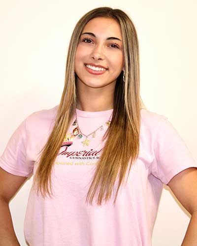 Smiling person wearing a pink t-shirt with 