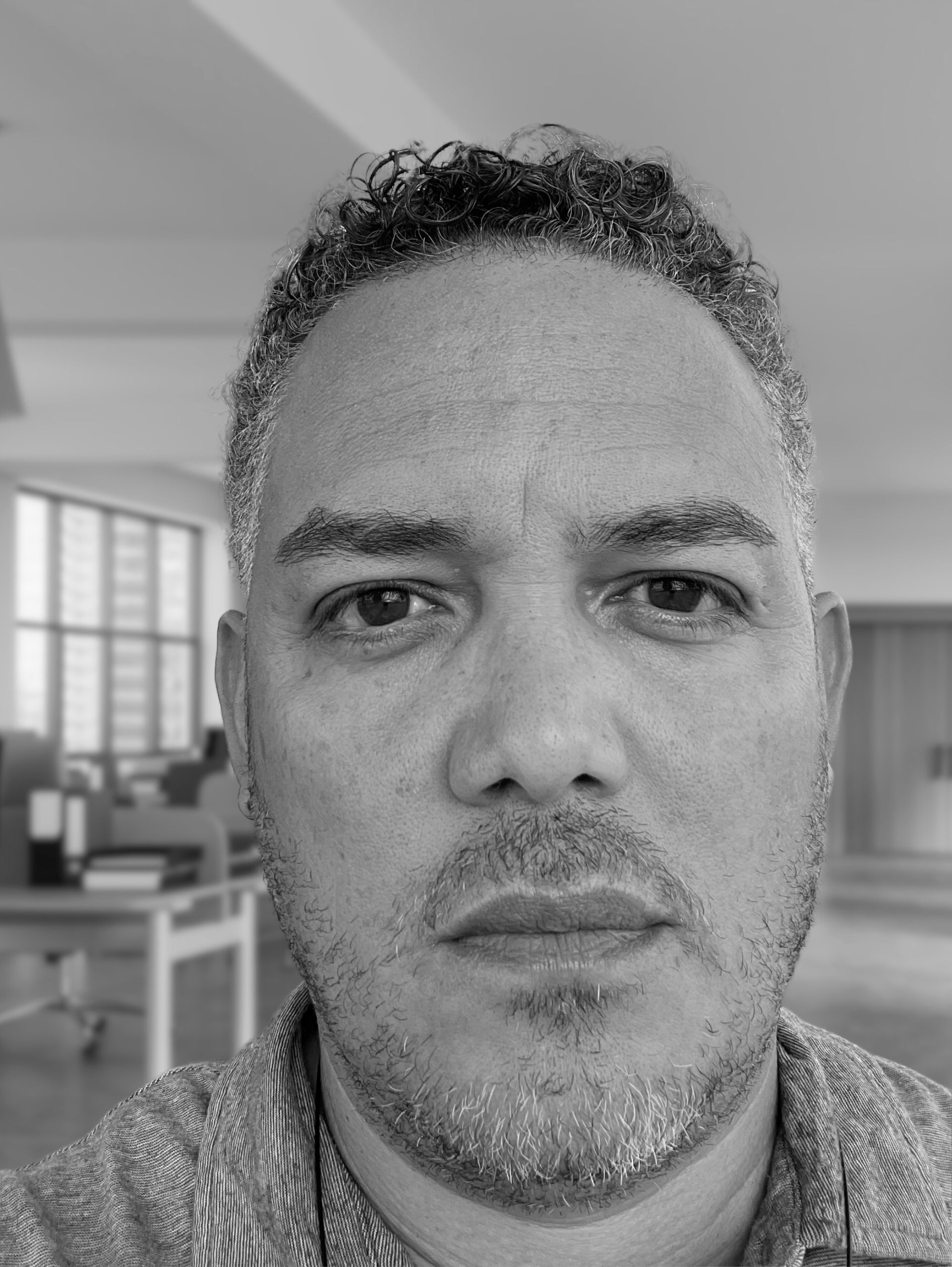 Nova Point Digital Creative Director Edwin Cruz with taking a selfie in a black and white photo.