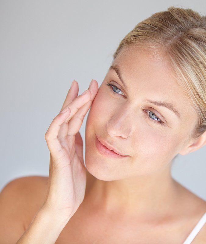 Lady Touching Her Smooth Face — Pensacola, FL — Physicians Cosmetic & Laser Center Lady Touching Her Smooth Face — Pensacola, FL — Physicians Cosmetic & Laser Center