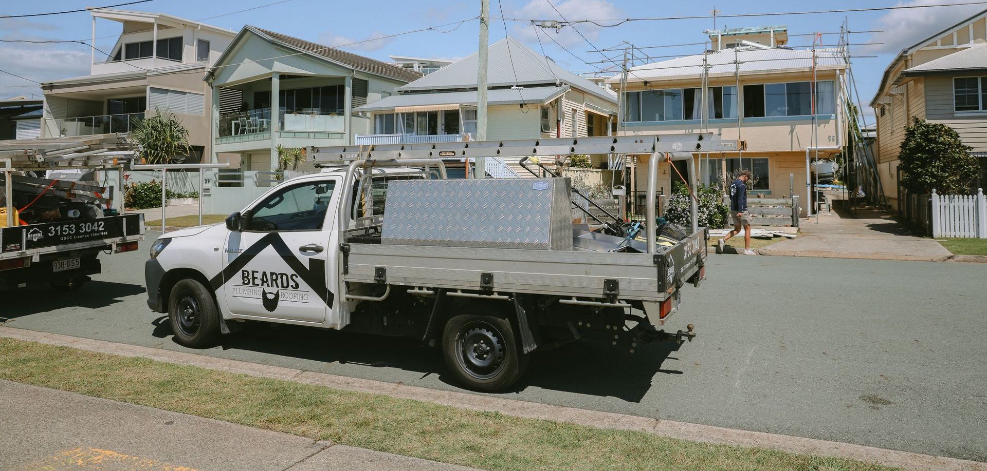 White Truck is Parked on the Side of the Road — Beards Roofing and Plumbing in Clontarf, QLD