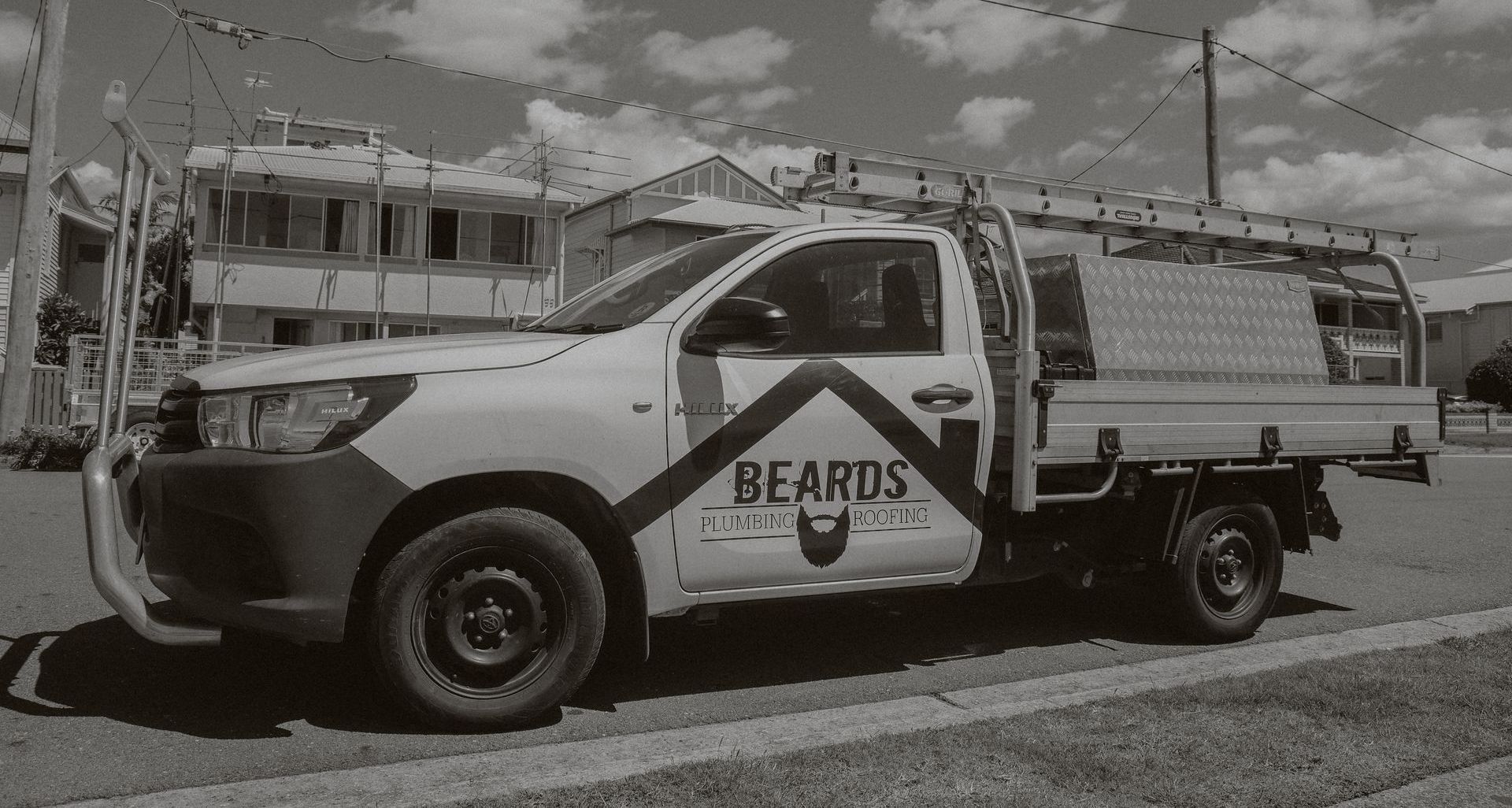 A Black And White Photo Of A Plumbing Truck With the Word Beards — Beards Roofing and Plumbing in North Lakes, QLD