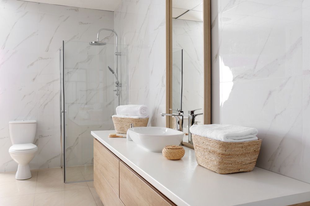 A Bathroom With Two Sinks, a Toilet, a Mirror and a Walk in Shower — Beards Roofing and Plumbing in Kallangur, QLD