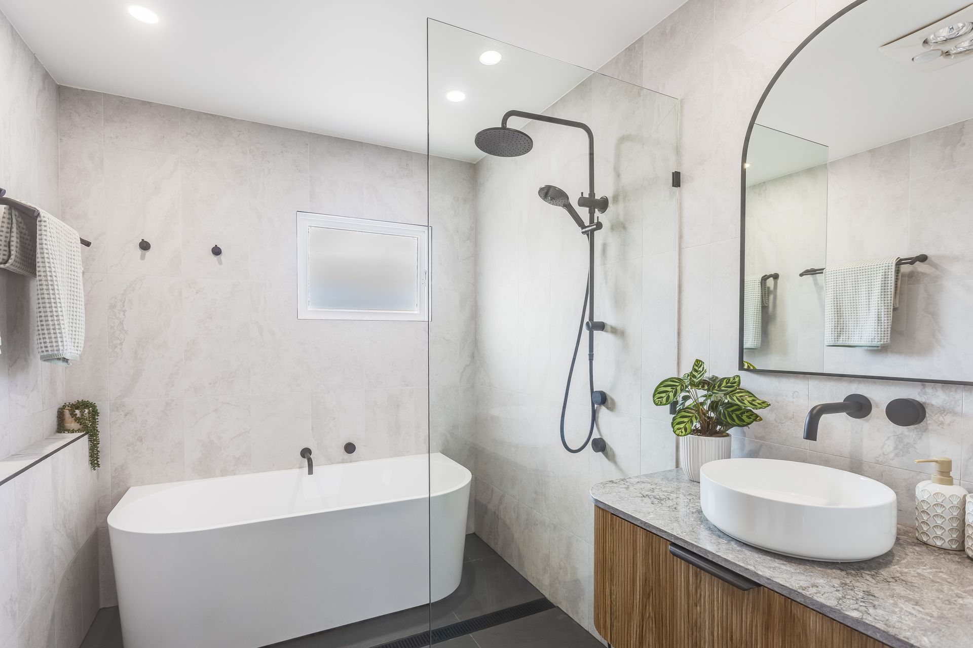 A Bathroom With A Sink, a Bath, a Mirror and a Walk in Shower — Beards Roofing and Plumbing in Morayfield, QLD