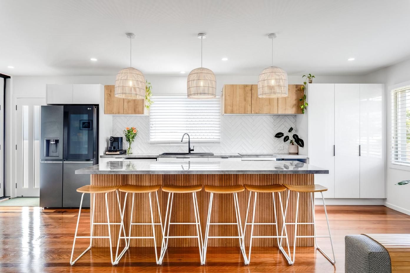 Kitchen With a Large Island , Stools and a Refrigerator — Beards Roofing and Plumbing in Clontarf, QLD
