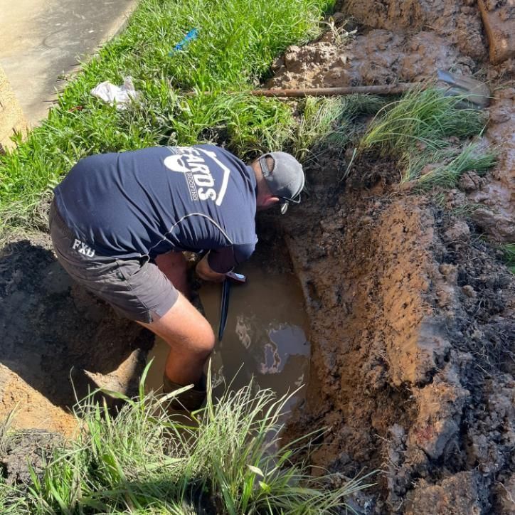 Man is Digging in the Dirt — Beards Roofing and Plumbing in Clontarf, QLD