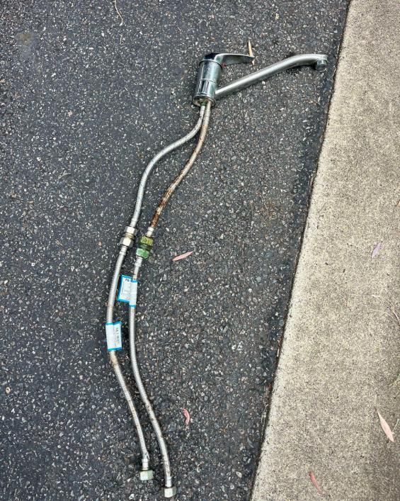 Faucet With Two Hoses Attached to It — Beards Roofing and Plumbing in Clontarf, QLD