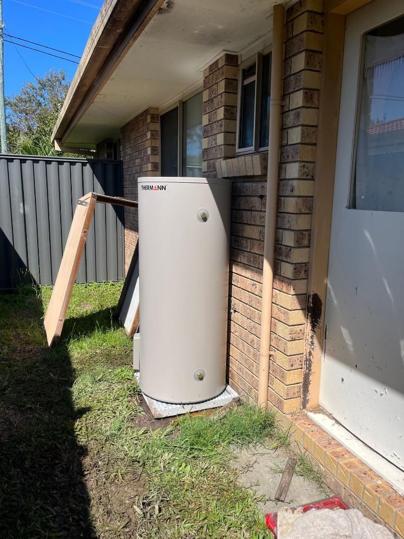 White Water Heater is Sitting Outside — Beards Roofing and Plumbing in Clontarf, QLD