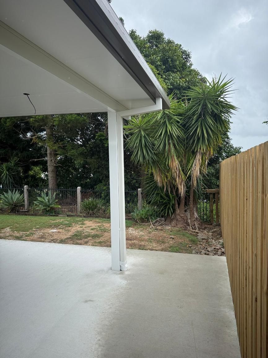 Patio With a Wooden Fence and a Tree — Beards Roofing and Plumbing in Clontarf, QLD