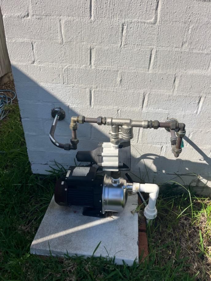 Water Pump is Sitting on Top of a Concrete Platform — Beards Roofing and Plumbing in Clontarf, QLD