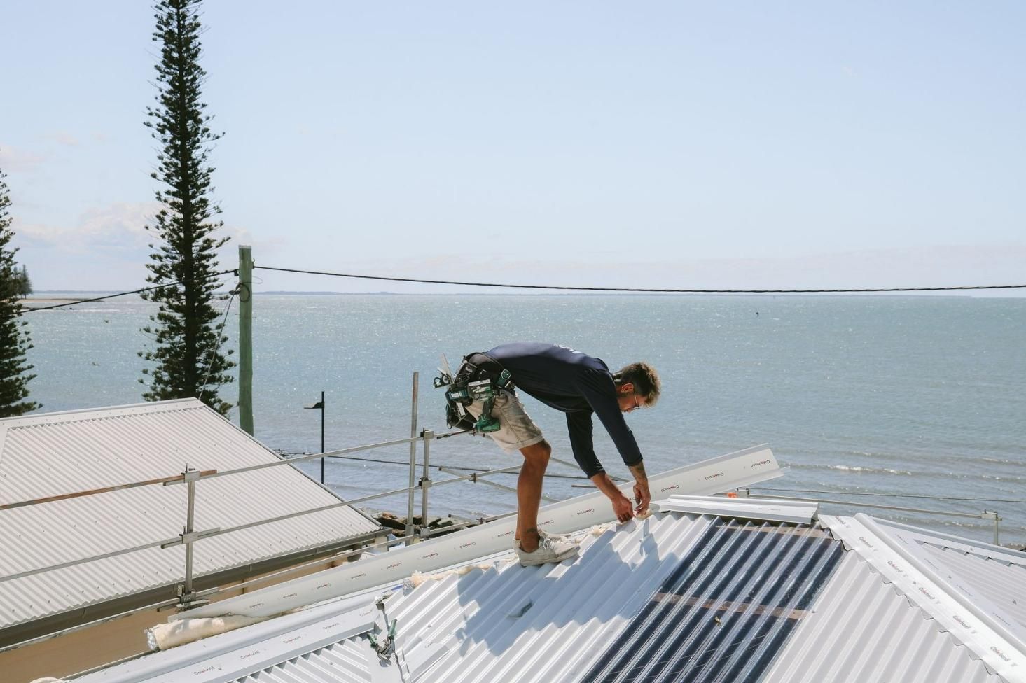Man is Working on a Roof — Beards Roofing and Plumbing in Clontarf, QLD