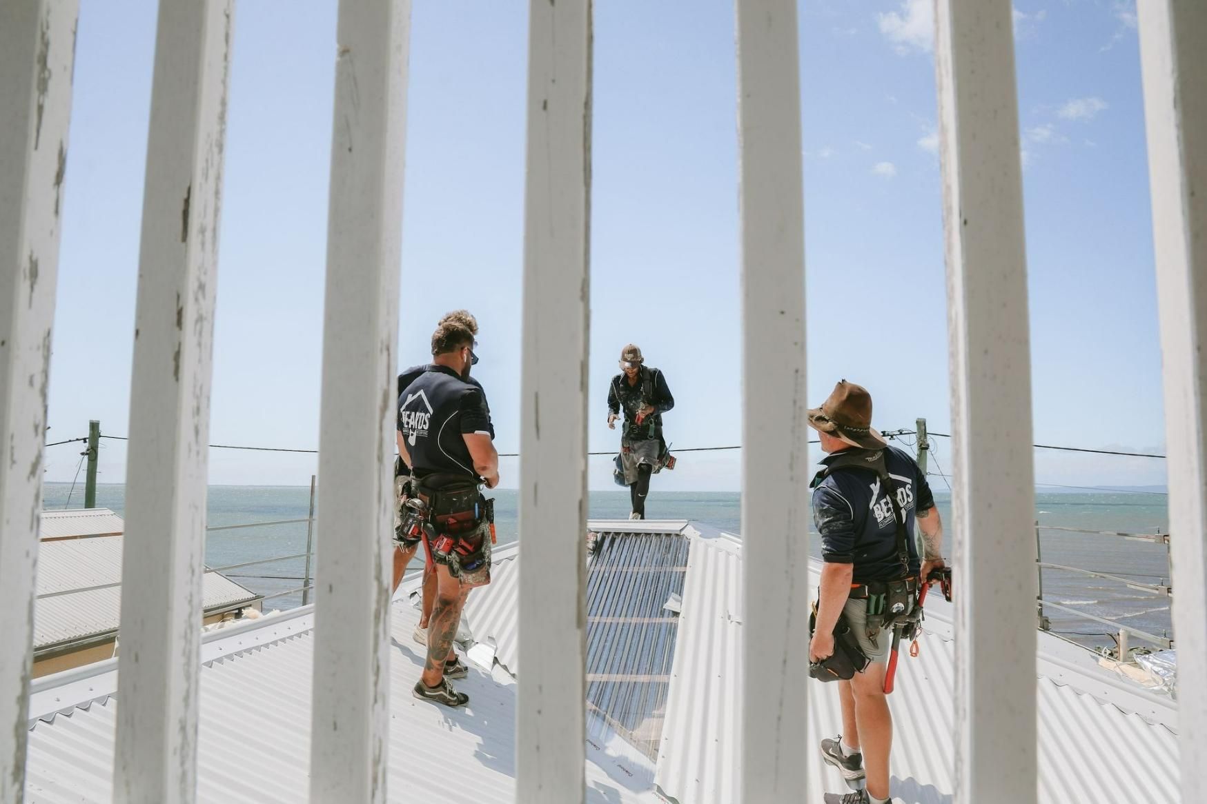 Group of People Are Working on Top of a Building — Beards Roofing and Plumbing in Clontarf, QLD