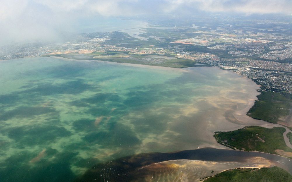 An Aerial View of a Large Body of Water With a City in the Background — Beards Roofing and Plumbing in Redcliffe, QLD