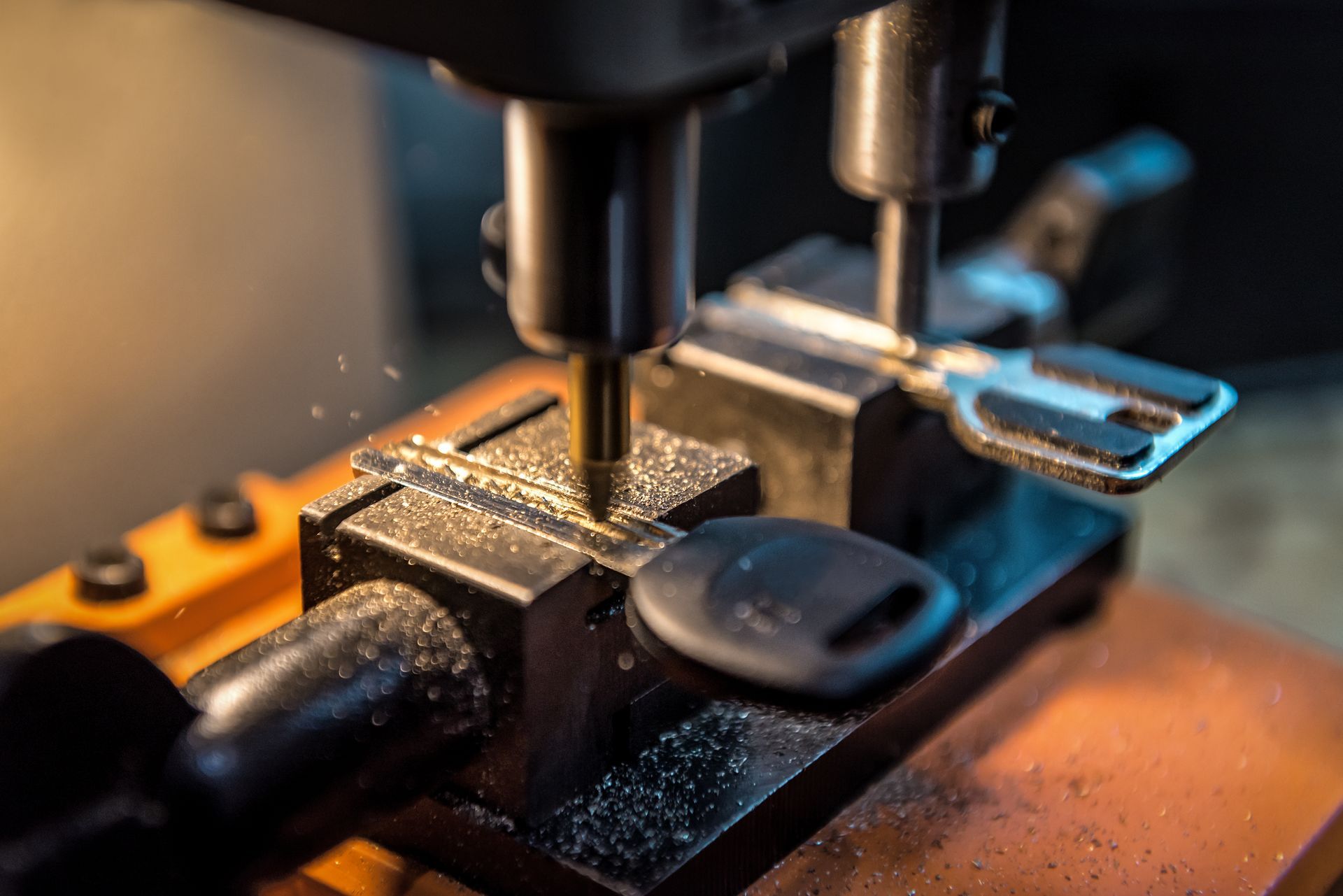 A close up of a key being cut on a machine.