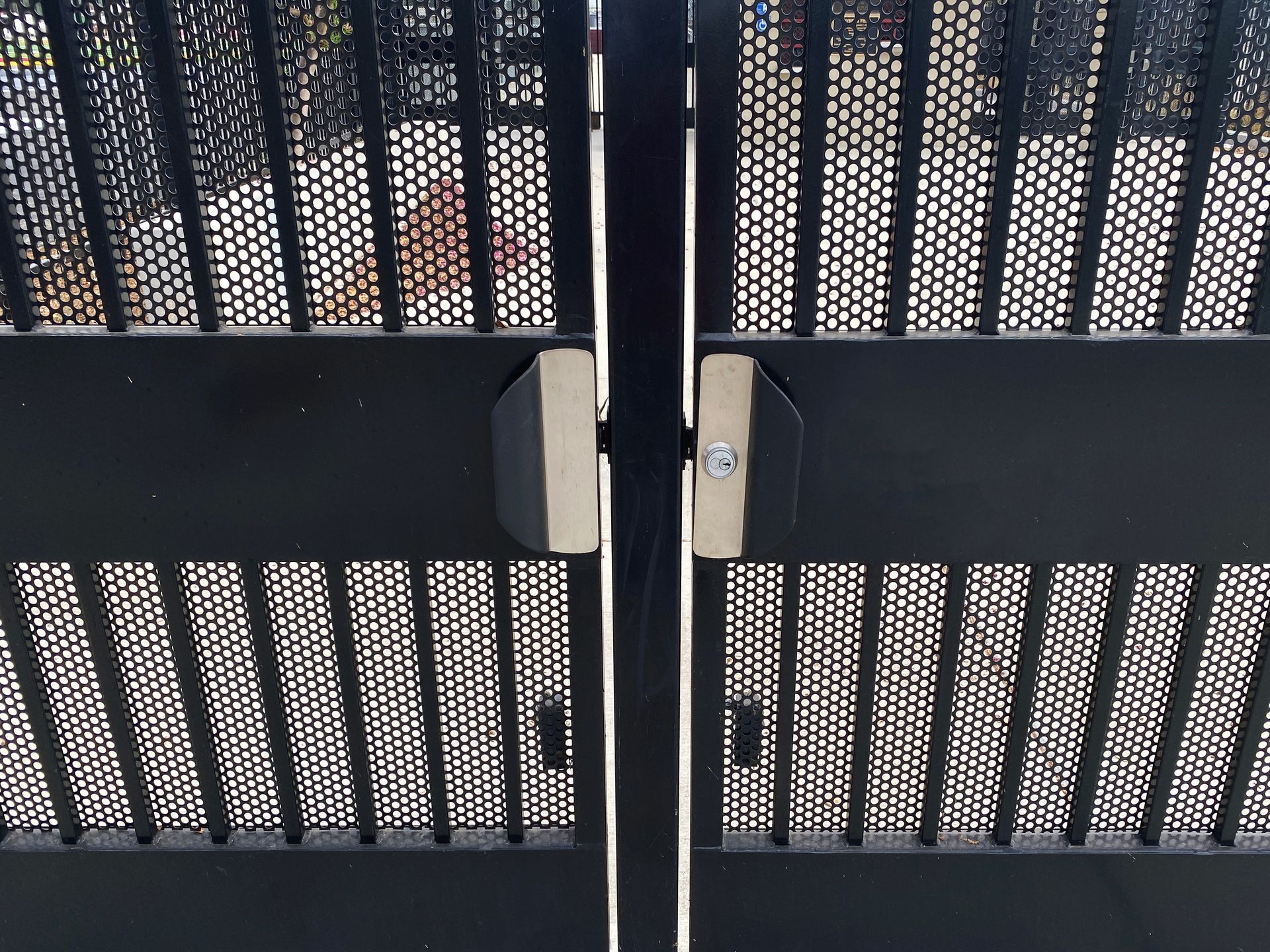 A close up of a metal gate with a lock on it.