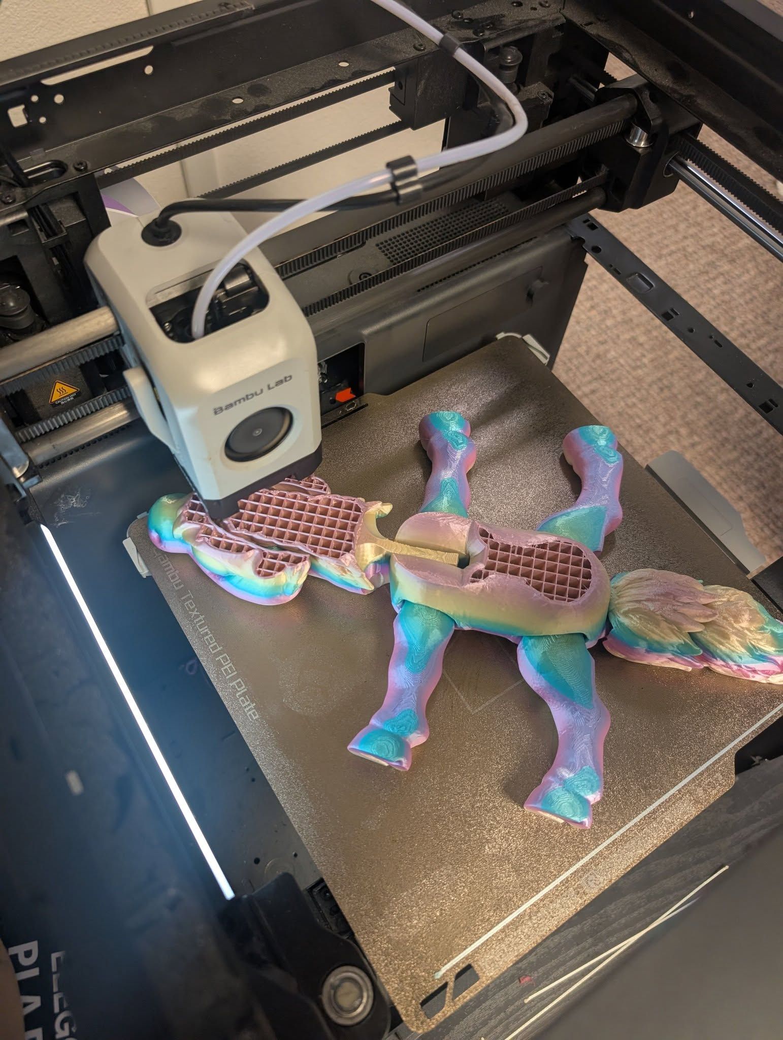 3D printer printing a colorful turtle on the build plate