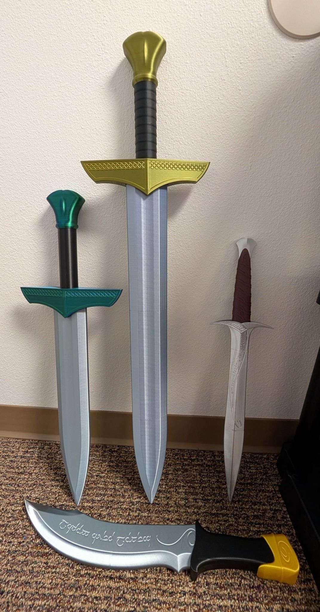 Toy swords and a dagger displayed upright on a carpeted floor, with a curved sword in front.