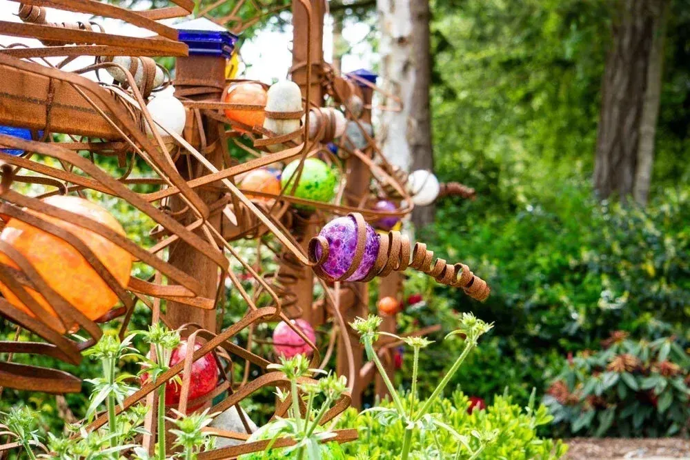 Kinetic garden panel of rock, steel and glass handmade by Robert Rochholz