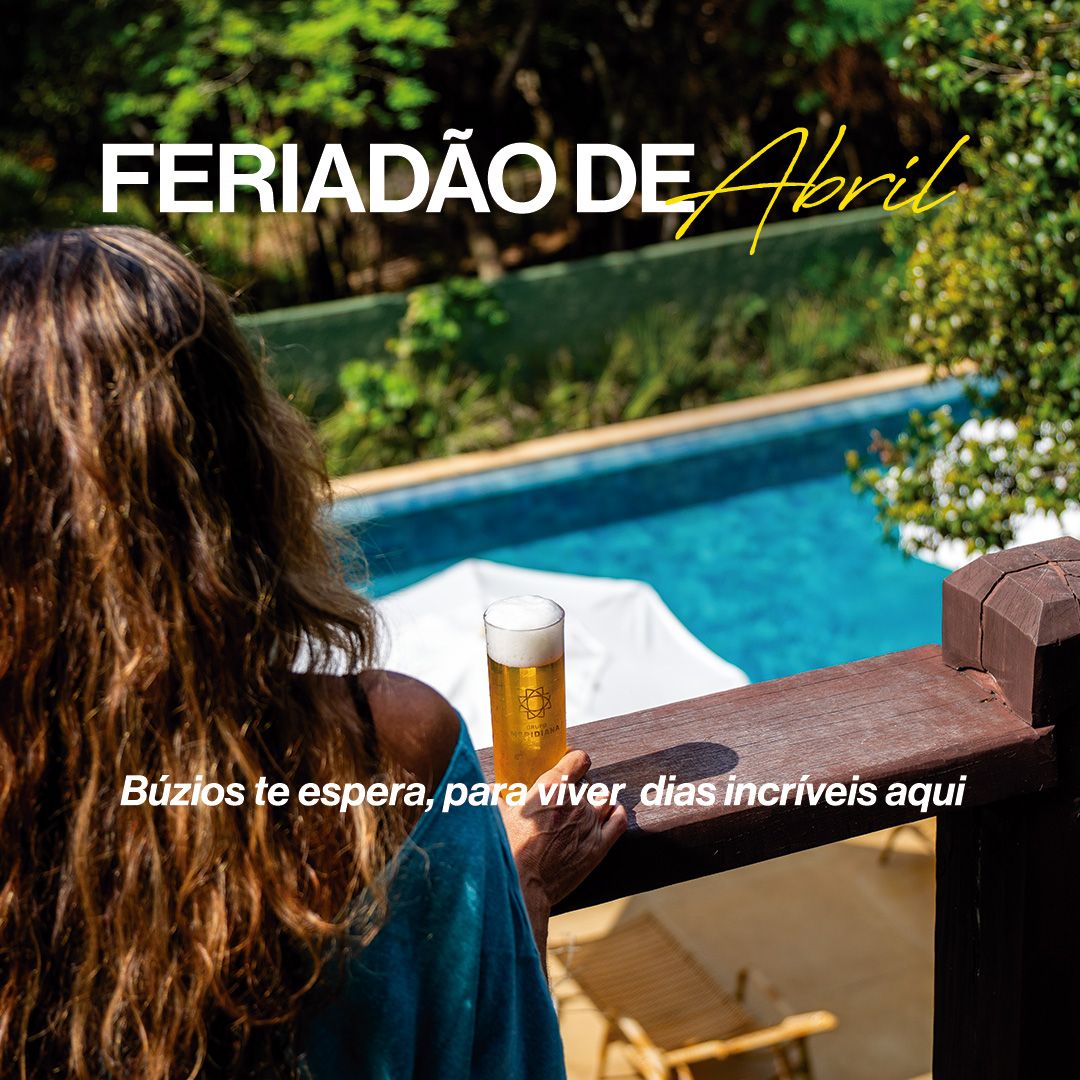 Woman drinking beer, looking at a lush green landscape. 