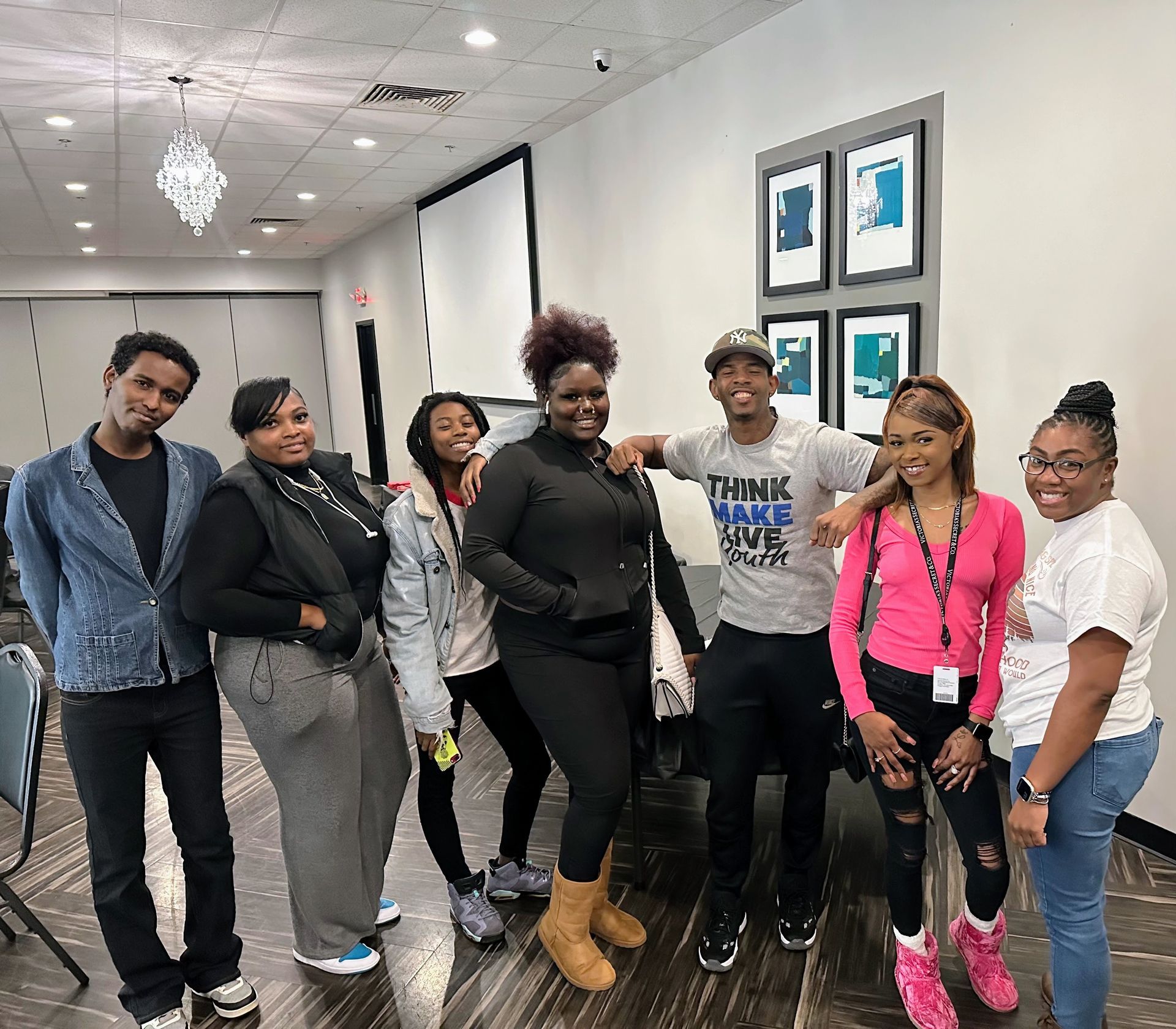 A group of people are posing for a picture in a room.