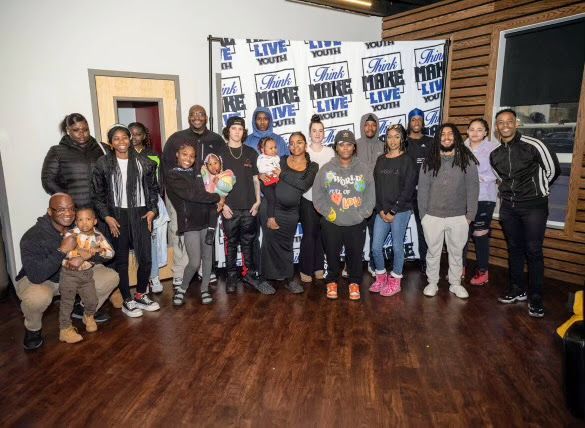 A group of people are posing for a picture in a room.