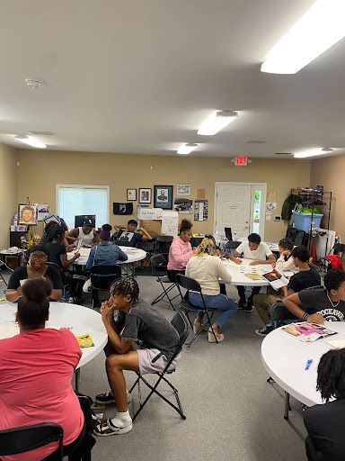 A group of people are sitting at tables in a room.