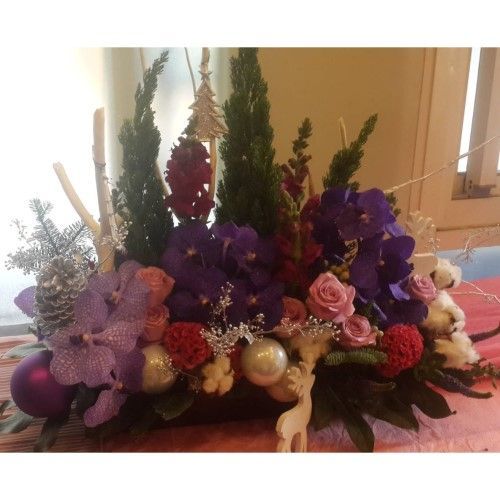 以紫色蘭花、銀色飾品和綠色葉子組成的插花，充滿節日氣氛的裝飾。