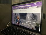 Laptop displaying a purple-themed website homepage with a woman and “Creative Vision Strategies” banner