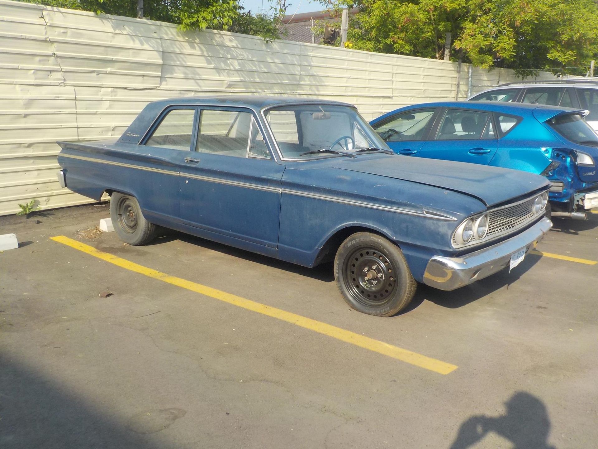 old collector vehicle parked in the Tip Top Auto Body parking lot
