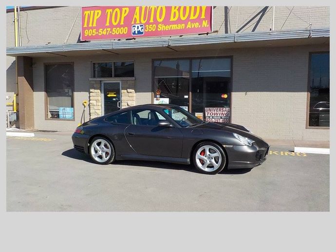Black sports car parked in front of Tip Top Auto Body