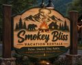 Smokey Blus vacation rentals sign with mountains, pine trees, bear, cabin, and campfire at dusk