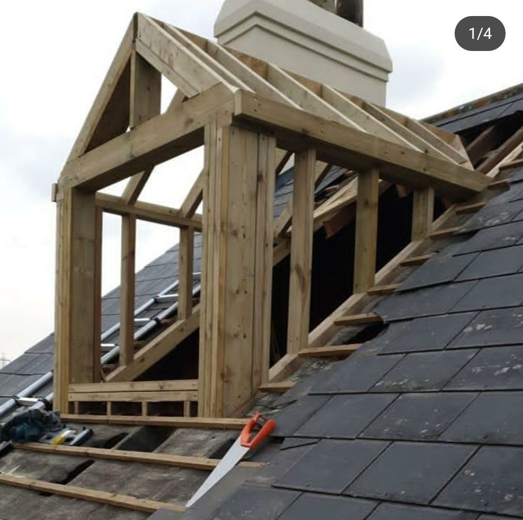 A wooden structure is being built on top of a roof
