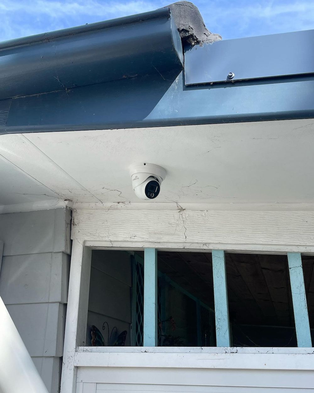 A Security Camera Is Mounted On The Roof Of A House — KARM Electrical Services In Corlette, NSW