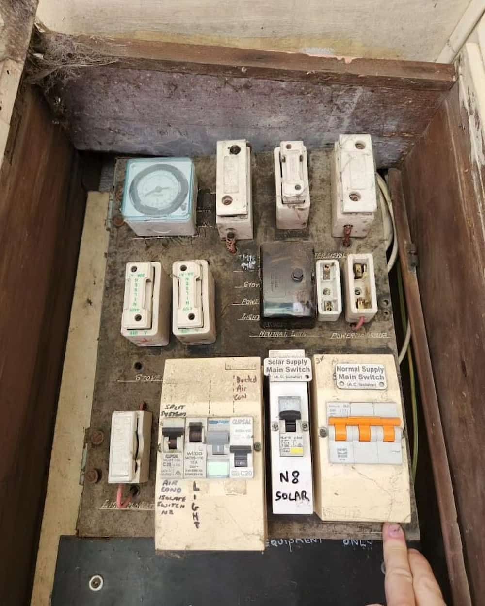 A Person Is Pointing At A Circuit Board With A Timer On It — KARM Electrical Services In Medowie, NSW