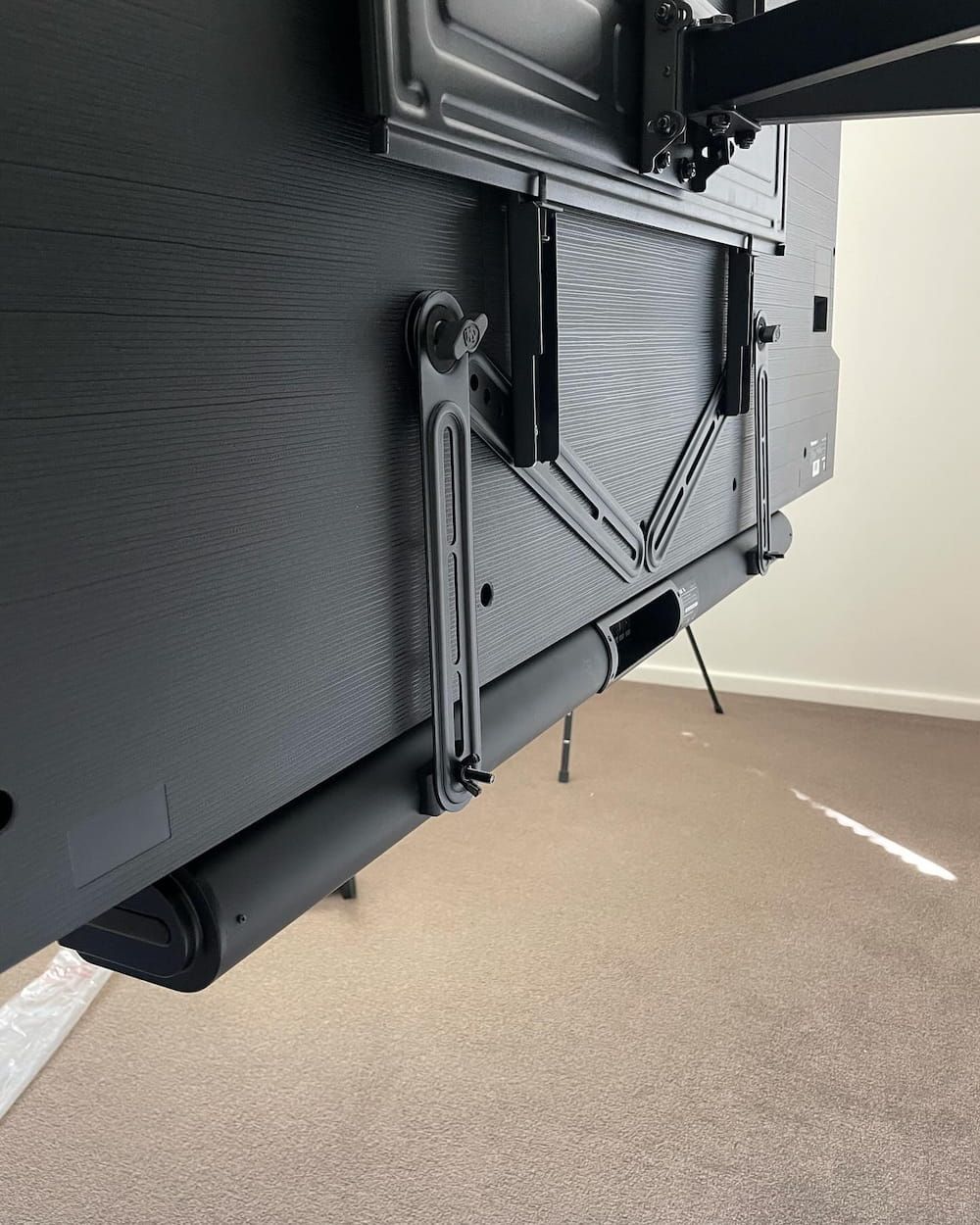 The Back Of A Flat Screen Tv Mounted On A Wall — KARM Electrical Services In Medowie, NSW