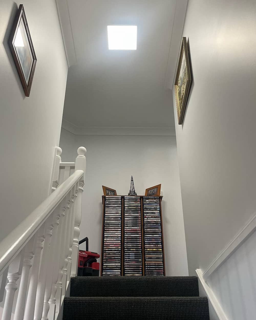 A Set Of Stairs Leading Up To A Cd Rack With A Light On Top — KARM Electrical Services In Medowie, NSW