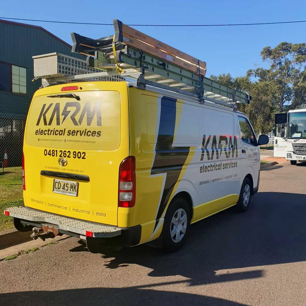 A Yellow And White Van For Electrical Services Is Parked On The Road — KARM Electrical Services In Raymond Terrace, NSW