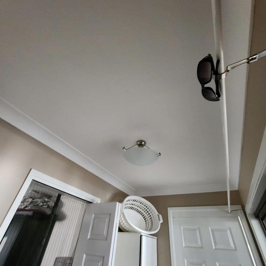 A Light Hanging From The Ceiling Of A Hallway — KARM Electrical Services In Salamander Bay, NSW