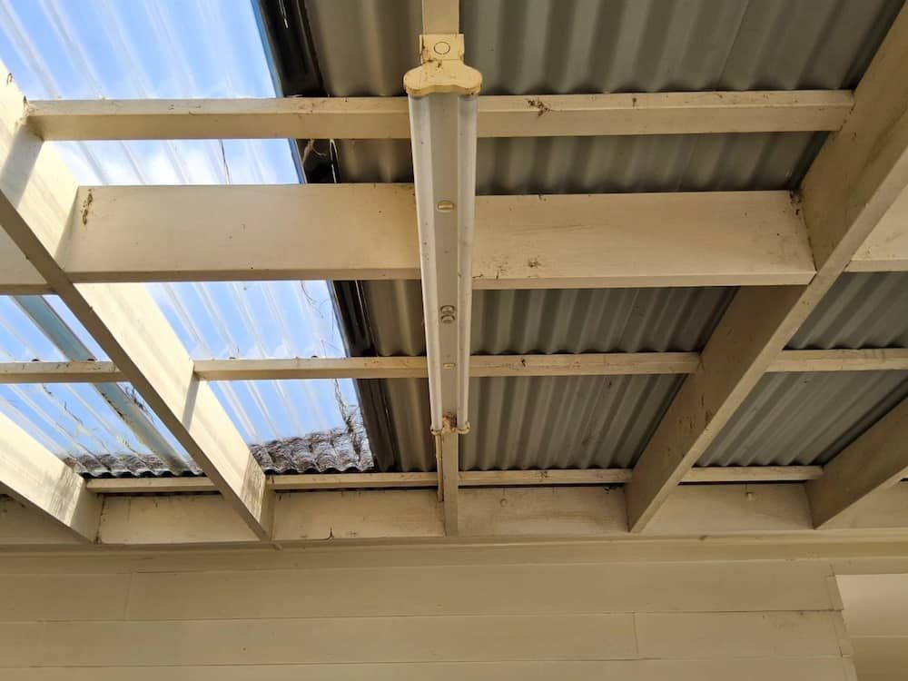A Light Is Hanging From The Ceiling Of A Building — KARM Electrical Services In Soldiers Point, NSW