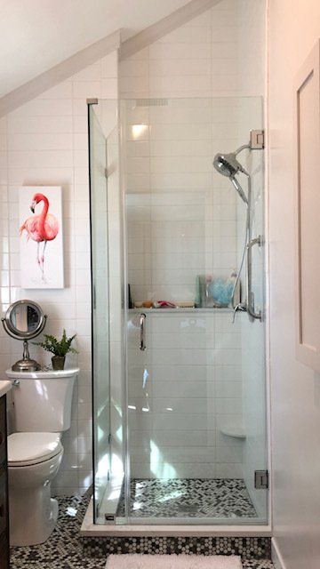 There is a picture of a flamingo on the wall above the toilet in the bathroom.