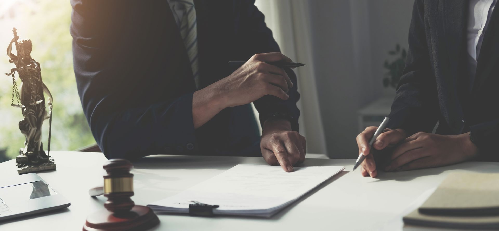 Two people at a desk review documents